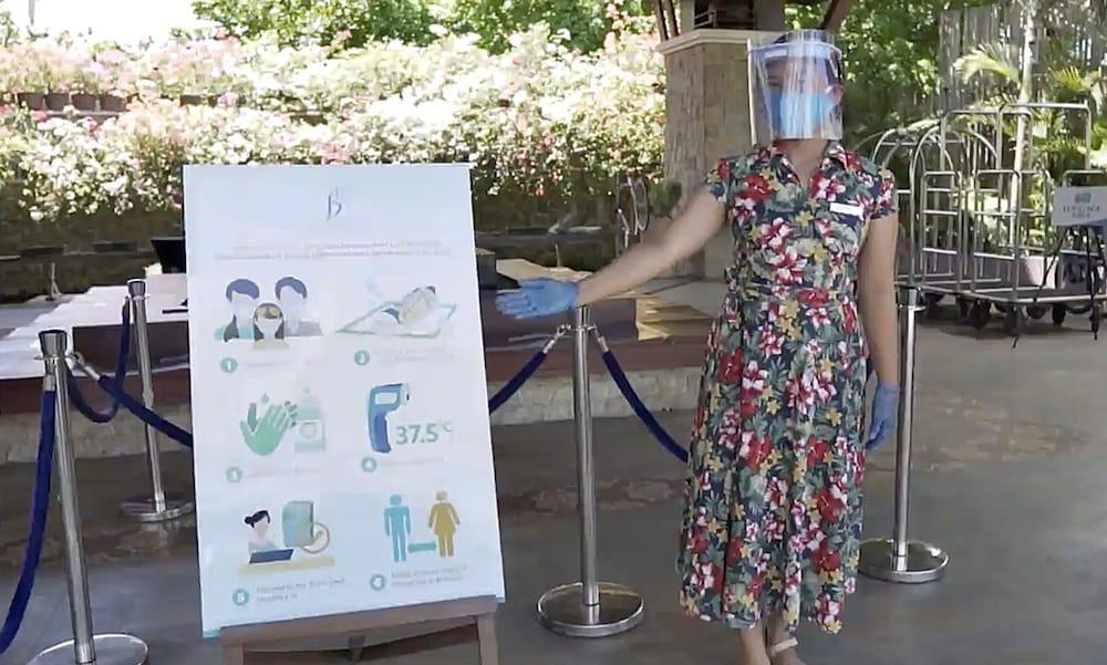 The Bellevue Resort Panglao Dış mekan fotoğraf A woman wearing a face shield at the entrance of a hotel in Paris, France